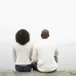 Couple sitting by lake --- Image by © Royalty-Free/Corbis